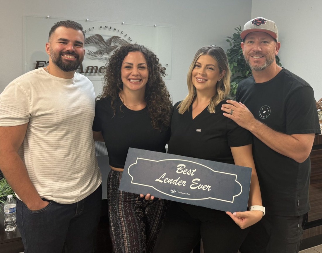 Clients holding a chalkboard sign reading "Best Lender Ever"